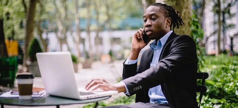Man using a laptop to plan moving back to the office in Washington DC