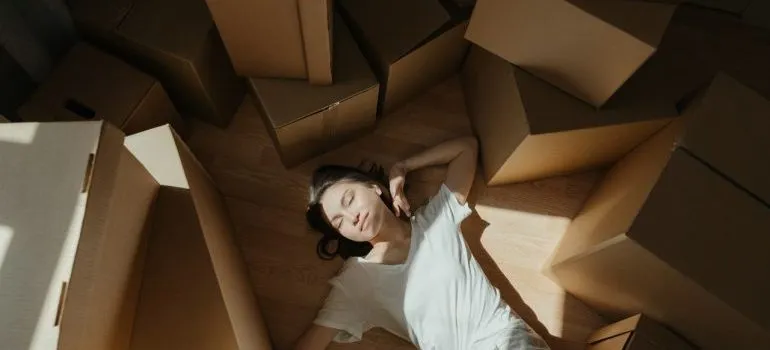 woman smiling amongst moving boxes
