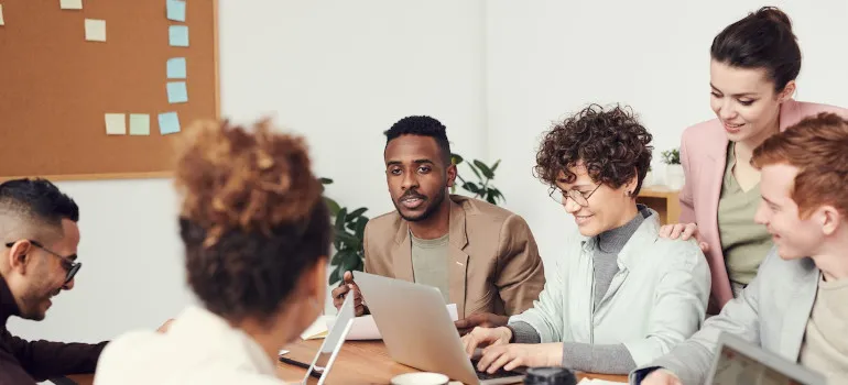 People sitting in the office in front of laptops