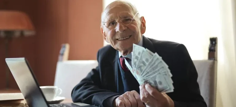 A happy senior holding paper money