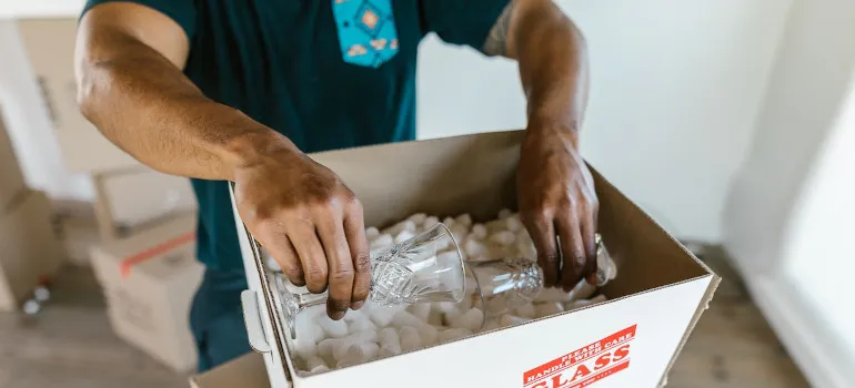 Man packing glasses in a box