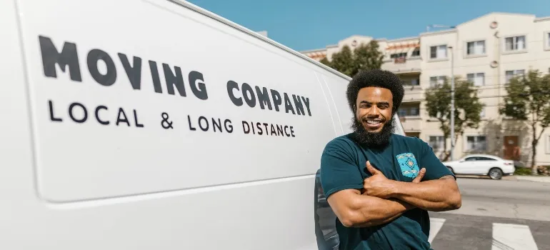 Moving professional standing in front of a moving van
