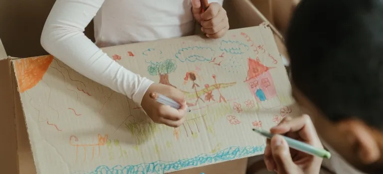 a dad coloring a box with his daughter in order to help her adjust to living in Washington DC