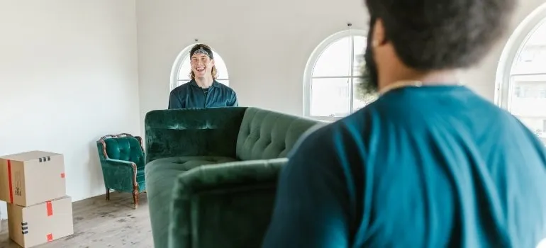 Two movers holding a couch