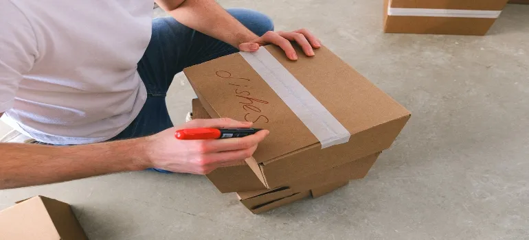 Man writing label on a box