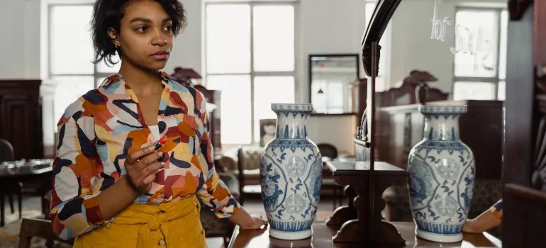 Woman in front of an antique vase and mirror in New Market, one of the best small cities to start a business in Maryland