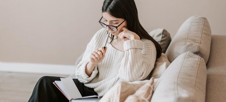 woman deciding if she should hire movers when moving on budget