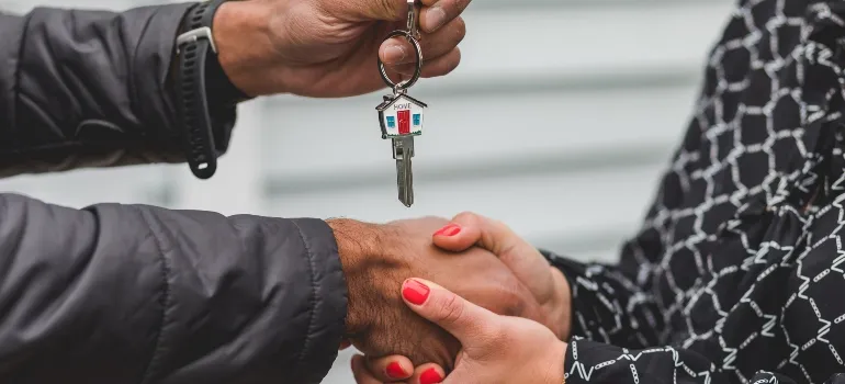 person giving another person keys