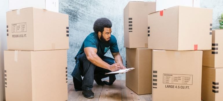mover evaluating a pile of cardboard boxes