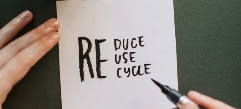 Sign that says "reduce reuse recycle" as that is one way to organize a green move to Washington