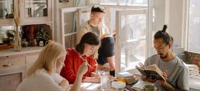 Friends sitting in the living room while sharing a flat in West Virginia