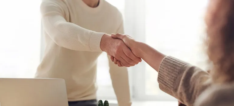 A man shaking hands with another person