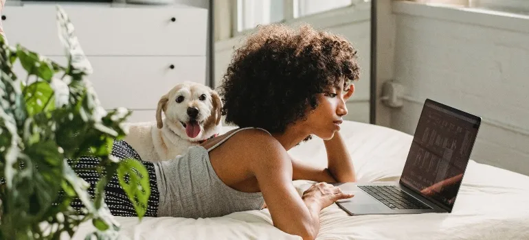 Woman looking at a laptop wondering whether to trust online moving reviews