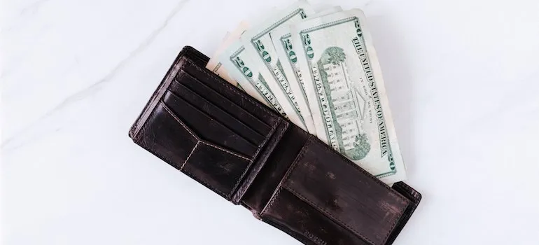 a black wallet with money in it