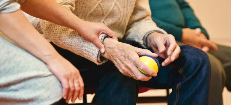 elderly couple holding hands