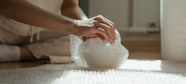 Picture of a person wrapping an item in bubble wrap