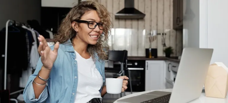 Picture of a woman making a call using her laptop and talking about making packing fun