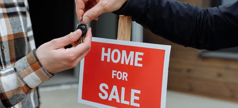 one man handing keys to other man
