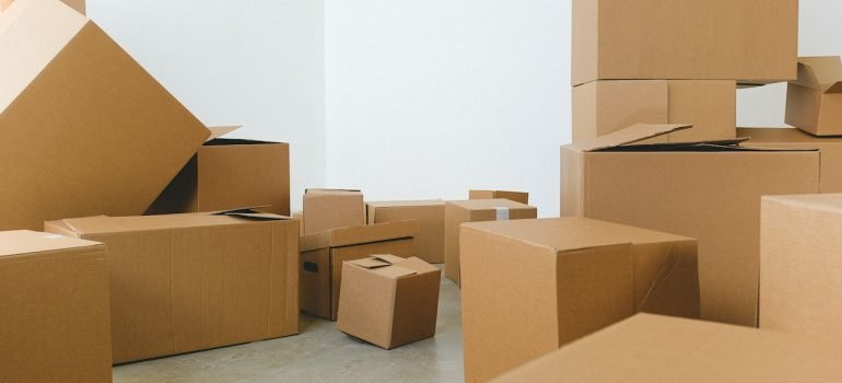 a pile of cardboard boxes scattered on the floor during relocation