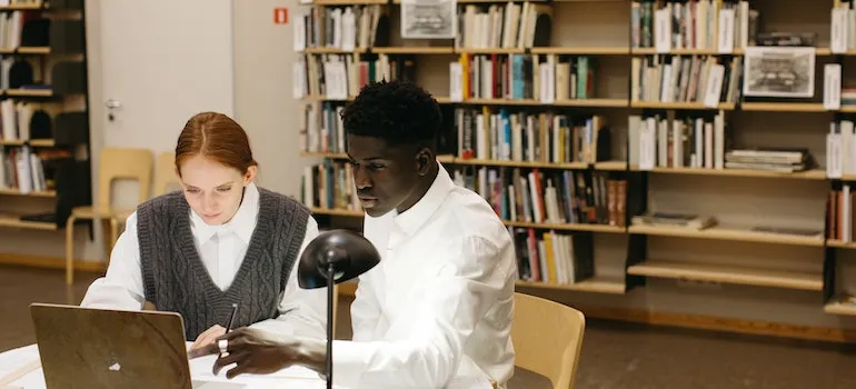 students moving from DC to NYC looking at laptop