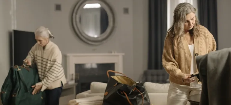 two elderly ladies packing according to our senior moving tips for relocation to Maryland