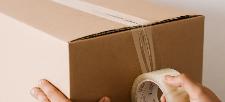picture of a man taping the box
