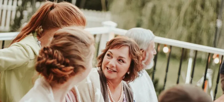 a lady in conversation with other women