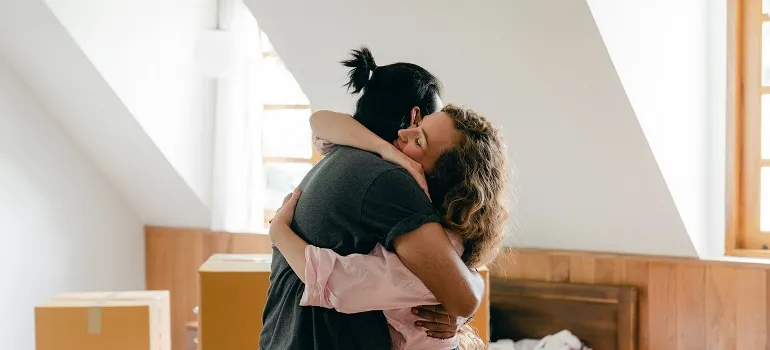 a couple hugging and implementing strategies for dealing with the stress of a move