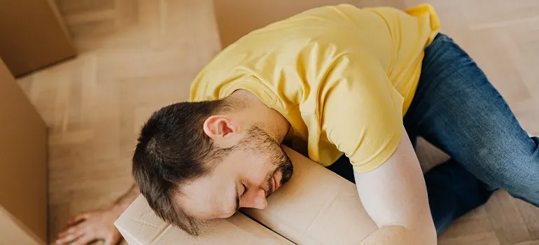 a man asleep on a moving box