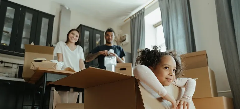 a family packing moving boxes