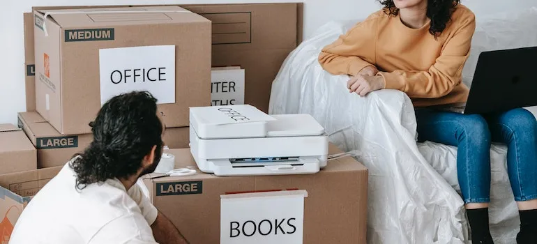 a couple packing their belongings and planning a stress-free relocation to DC