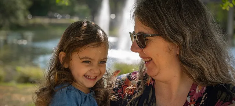 a mother smiling with her daughter, overcoming the challenges of moving from North Potomac to Clarksburg with ease