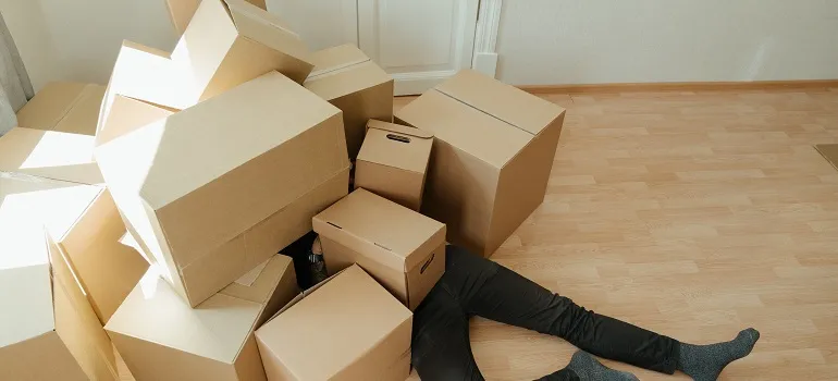 a man having difficulties with his moving boxes