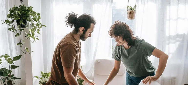 a couple arranging their living room