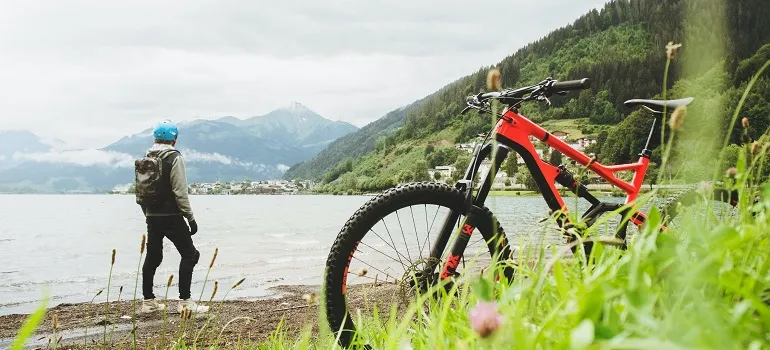 a man taking a break for biking to enjoy the scenery