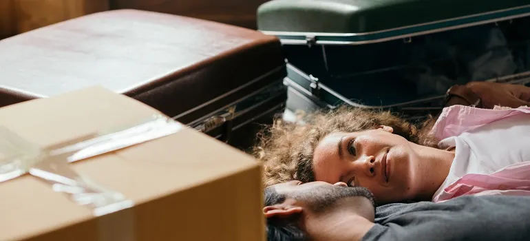 a couple surrounded by suitcasses