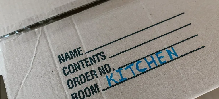 A moving box labelled "kitchen".