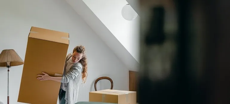 a girl trying not to damage the walls when moving out of your flat