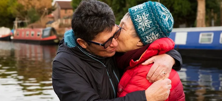 an elderly couple embracing
