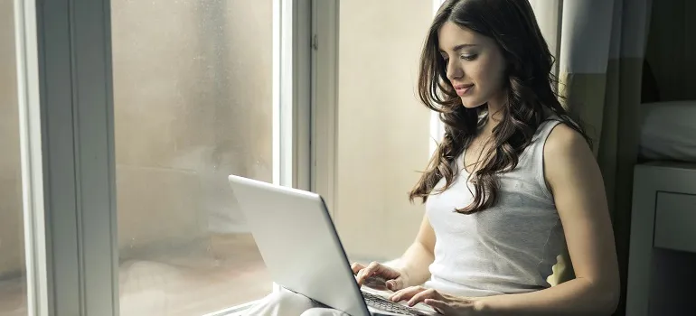 a girl using her laptop inside her home