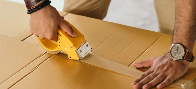 one of our residential movers in Maryland packing a moving box