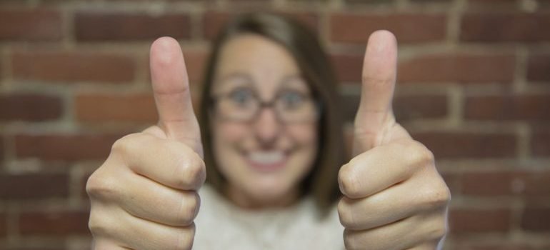 Aa woman showing thumbs up.