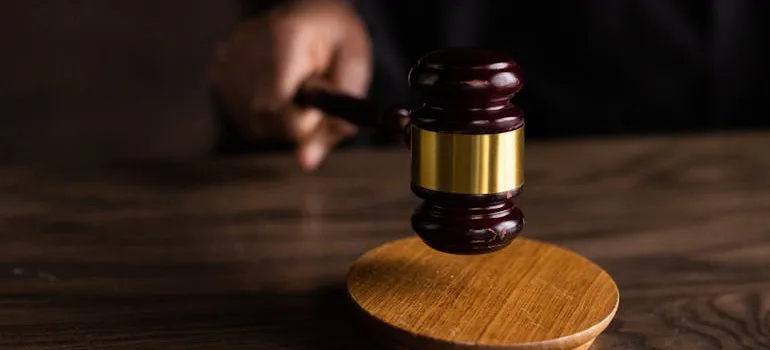 A wooden hammer symbolizing the legal regulations you need to know when involved in cross country moving.