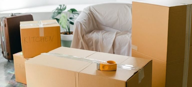 moving boxes and a covered couch