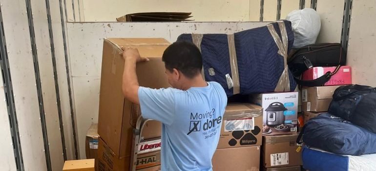 A professional mover loading a moving truck.