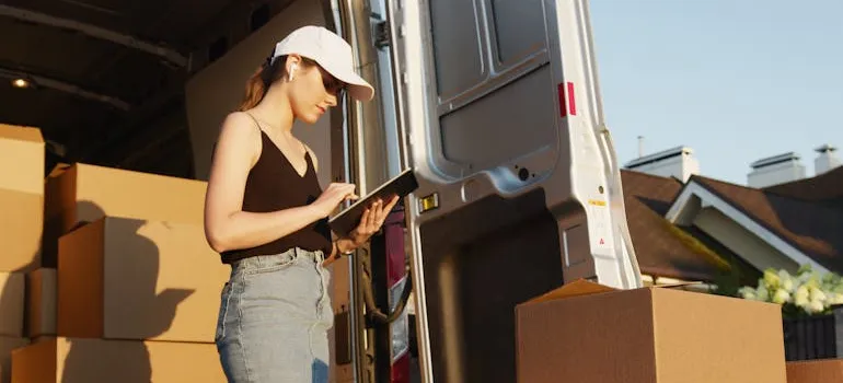 A person checking a list before one of the local moves.