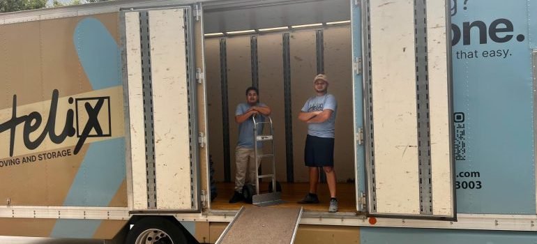 Movers inside a moving truck.