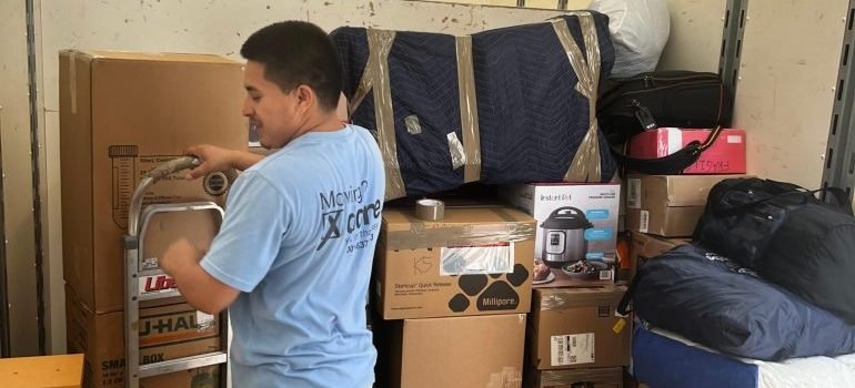 A professional mover loading a moving truck.