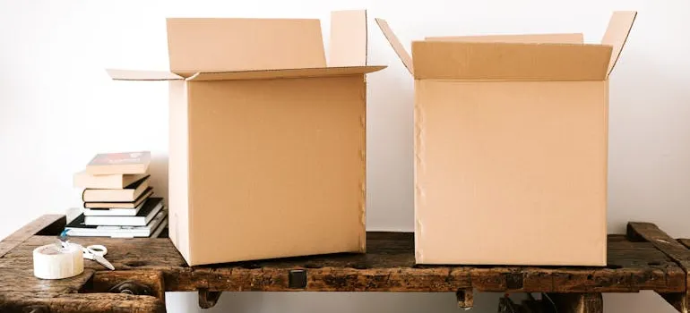 A couple of boxes on a table packed after finding out how to avoid stress when moving to North Potomac.