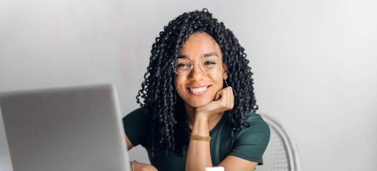 A person smiling after reading reviews online to find reliable movers in Montgomery County.